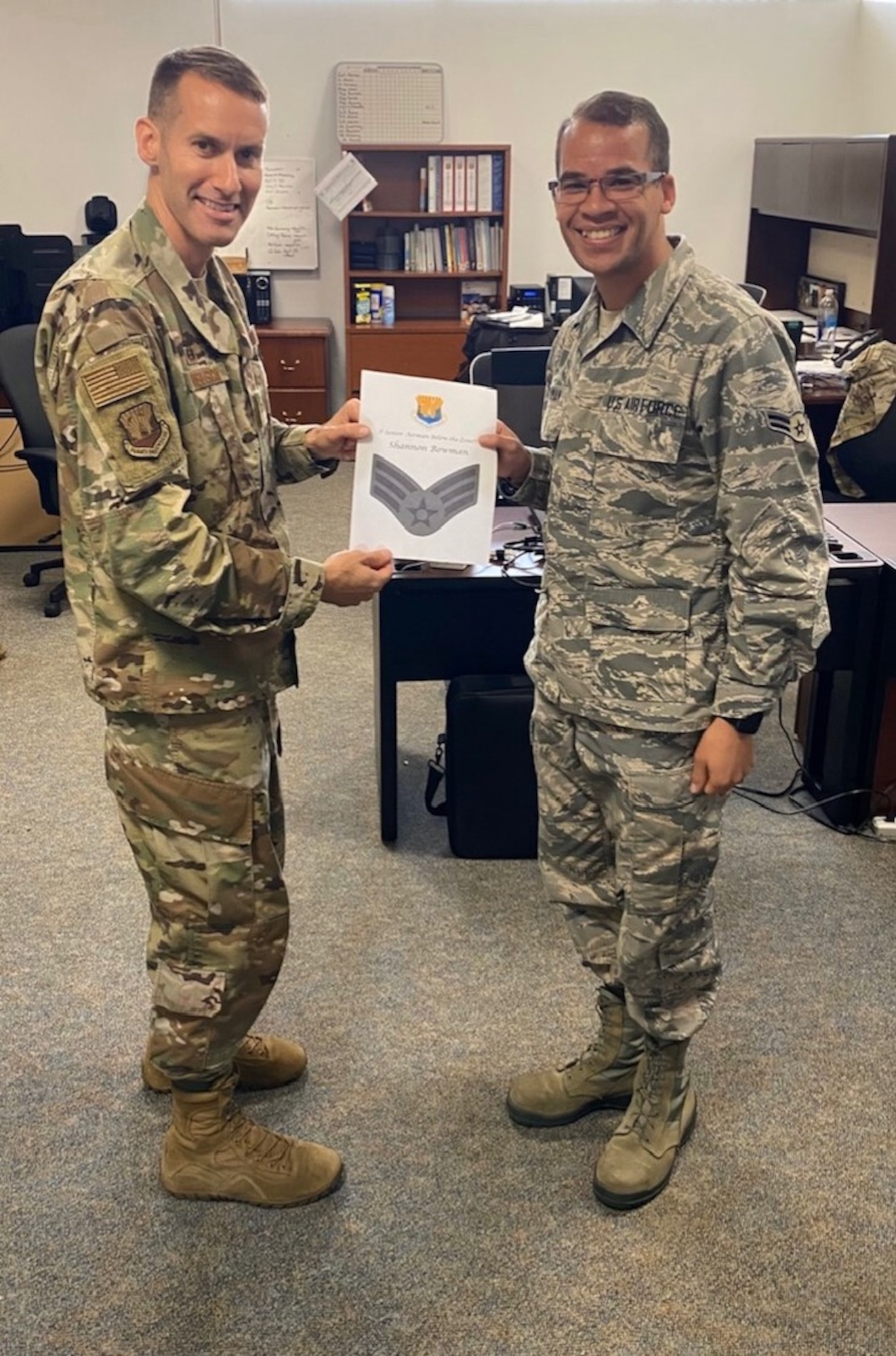 U.S. Air Force Col. Steve Snelson (left) the 6th Air Refueling Wing commander, presents a certificate to Airman 1st Class Shannon Bowman (right) a 6th ARW photojournalist, March 17, 2020, at MacDill Air Force Base, Fla.