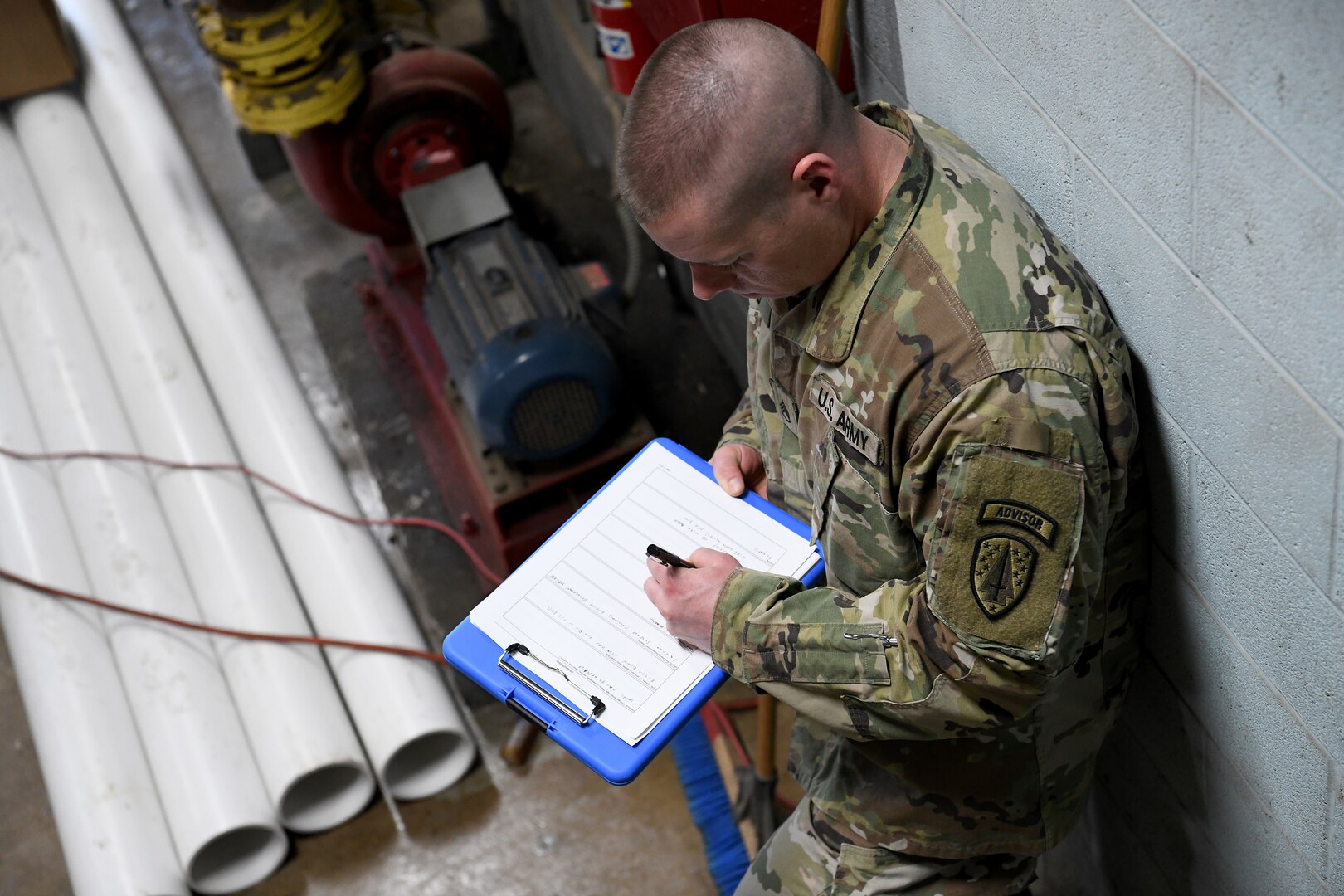 U.S. Army Staff Sgt. Lucas Budd, an engineer adviser assigned to the Northwest Joint Engineer Assessment Team, takes notes during a site survey April 4, 2020, at Upper Sandusky High School. Ohio National Guard members were assessing whether the school is suitable for use as an alternate medical facility, if COVID-19 cases increase beyond what existing hospitals in the state can manage.