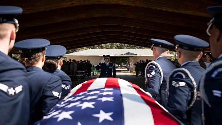 Staff Sgt. Jourdan Clark, 96th Medical Group, salutes as pallbearers carry the casket during the Honor Guard graduation ceremony, March 6, at Eglin Air Force Base, Fla.