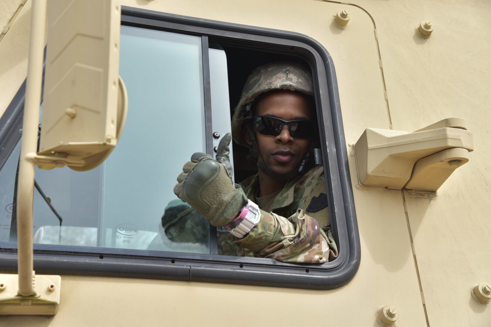 Spc. Gabriel Rushing of the Pennsylvania National Guard's 1/104th Cavalry gives a thumbs-up before driving a load of special needs cots from the Norristown State Hospital April 3, 2020, to the Federal Emergency Management Agency field hospital at Temple University in Philadelphia.