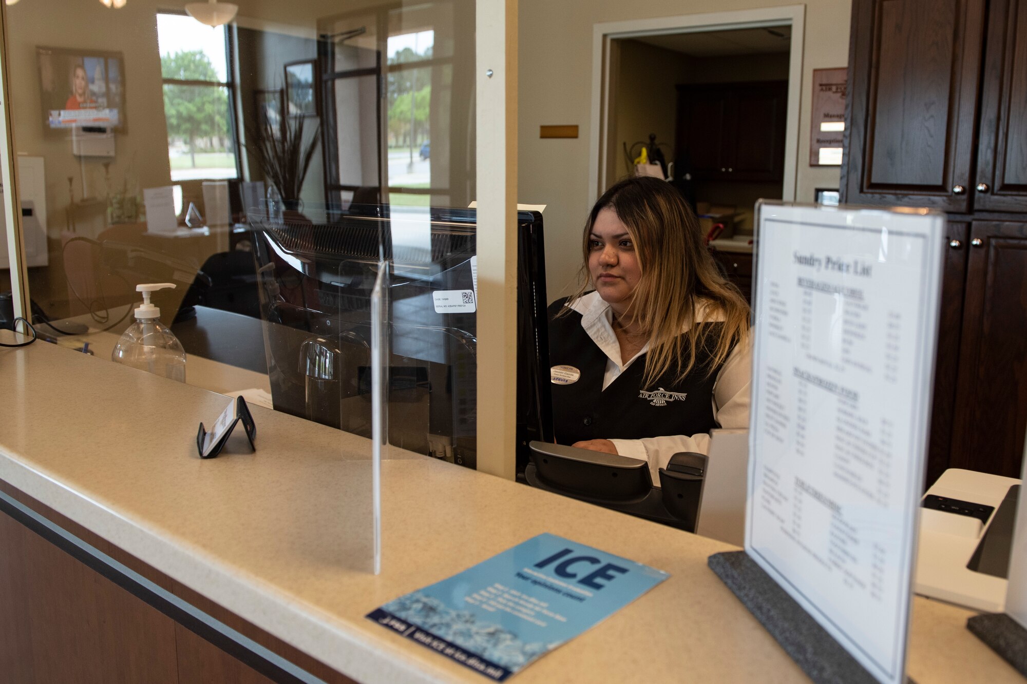 A photo of a worker checking reservations.