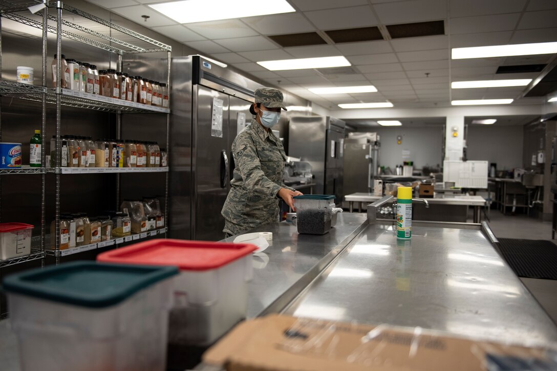 A photo of a worker throwing away expired food.