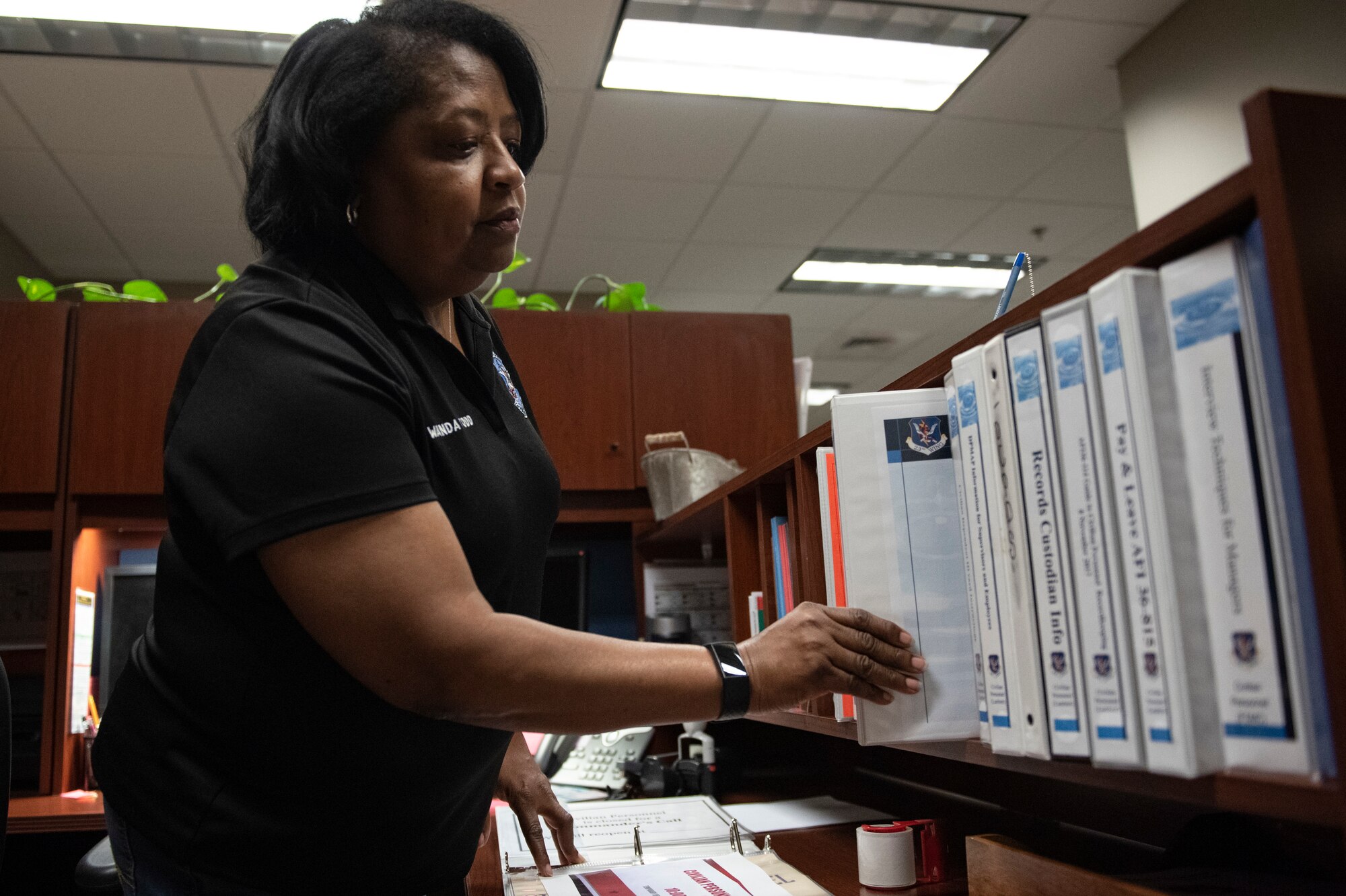 A photo of a worker tracking honorary awards.