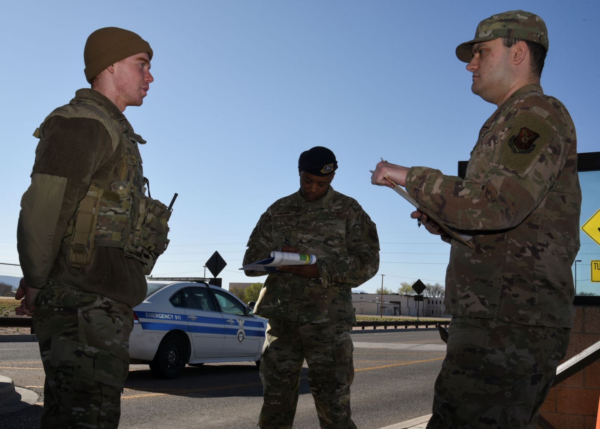 A team asks questions to a security forces member at the Truman Gate
