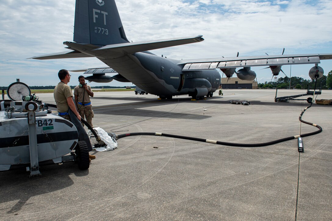 Photo of Airmen performing an in-flight refueling hose change.