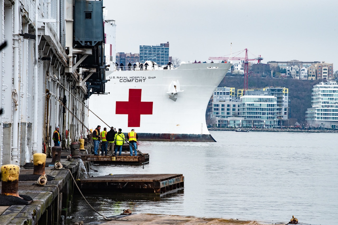 The USNS Comfort moves though the water and approaches the pier where it will dock.