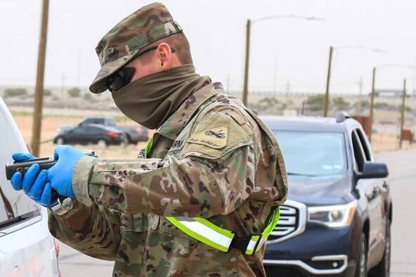 Service members make face masks.