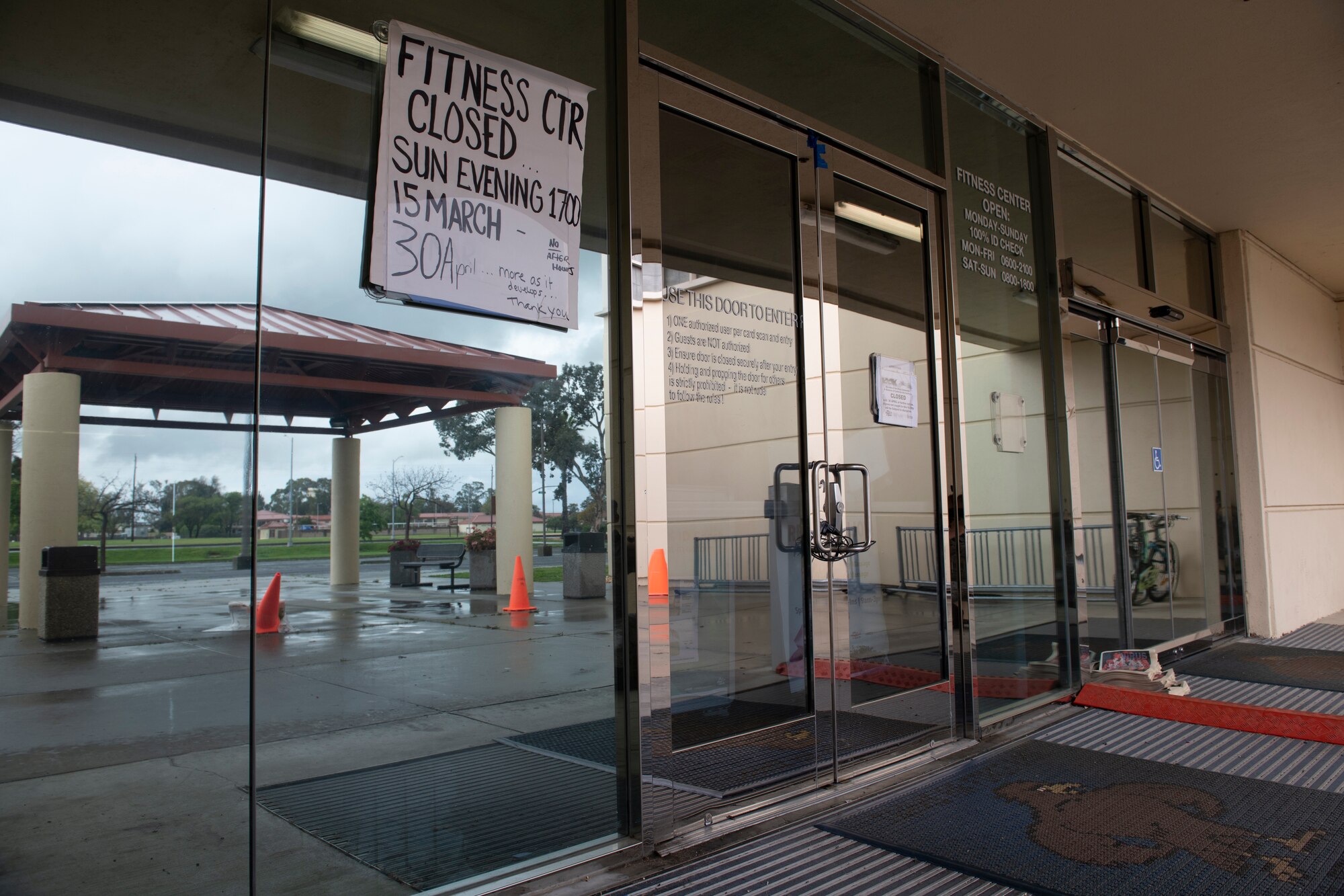 A sign on the front of the gym saying the gym is closed.