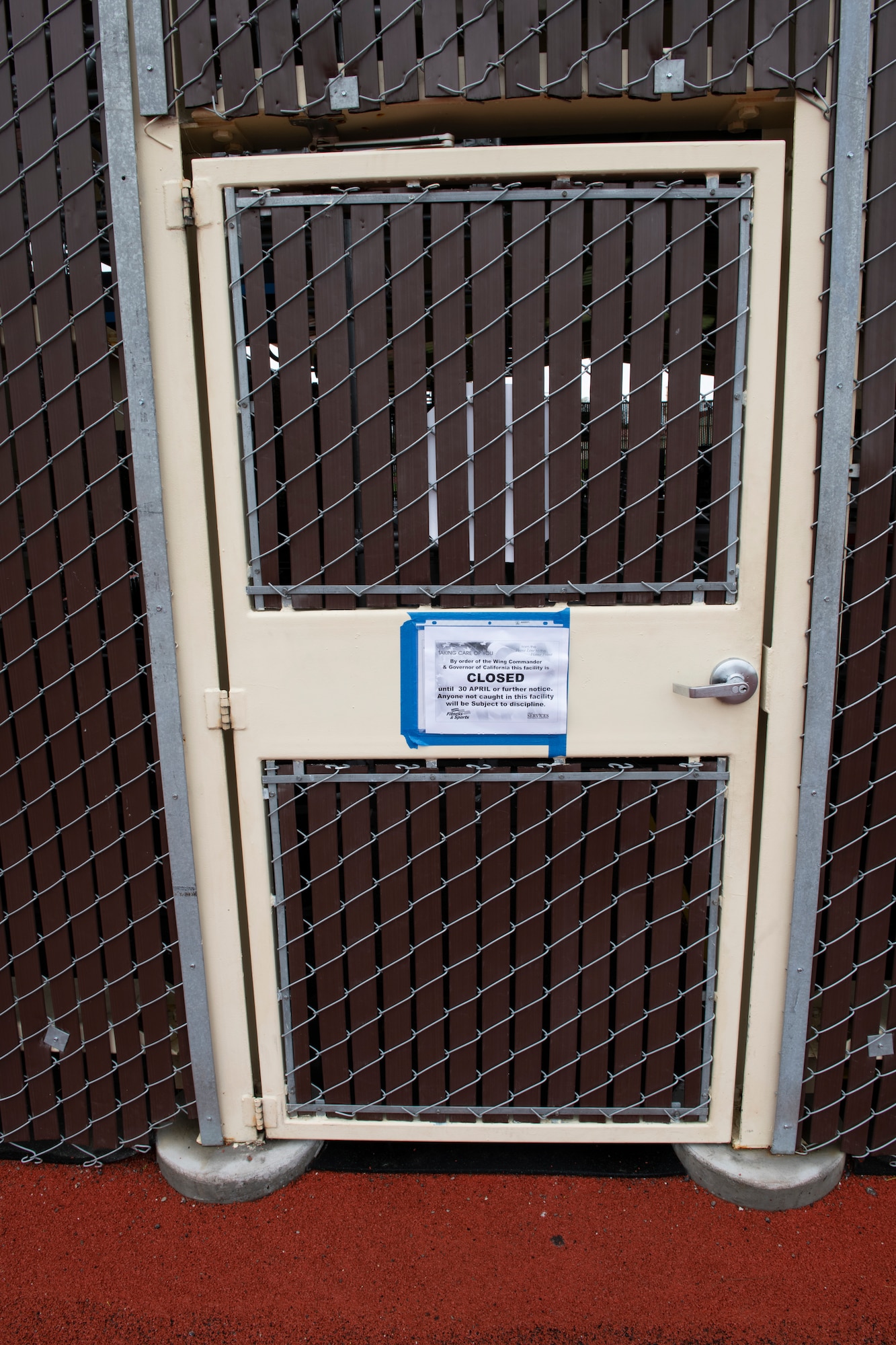 A closed fence with a sign saying gym is closed.