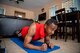 Staff Sgt. Kevin assumes a planking elbow position on a blue workout yoga mat at his home in Las Vegas.