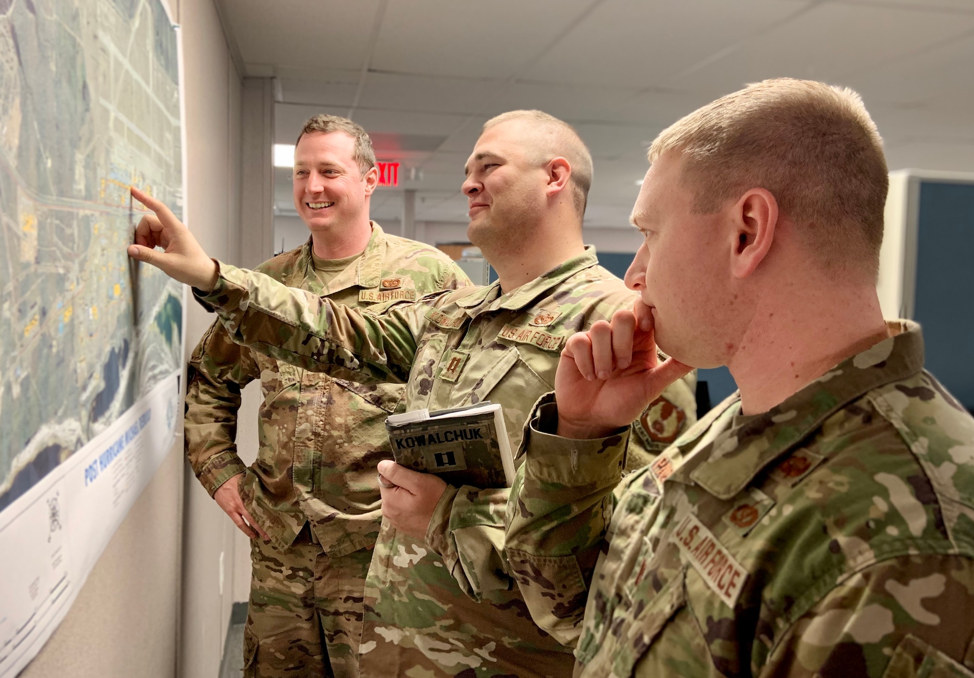 From left, Capts. Zach Bierhaus, Kyle Kowalchuk and Will Page discuss rebuild plans for both the flightline and support districts on Tyndall AFB, Fla.