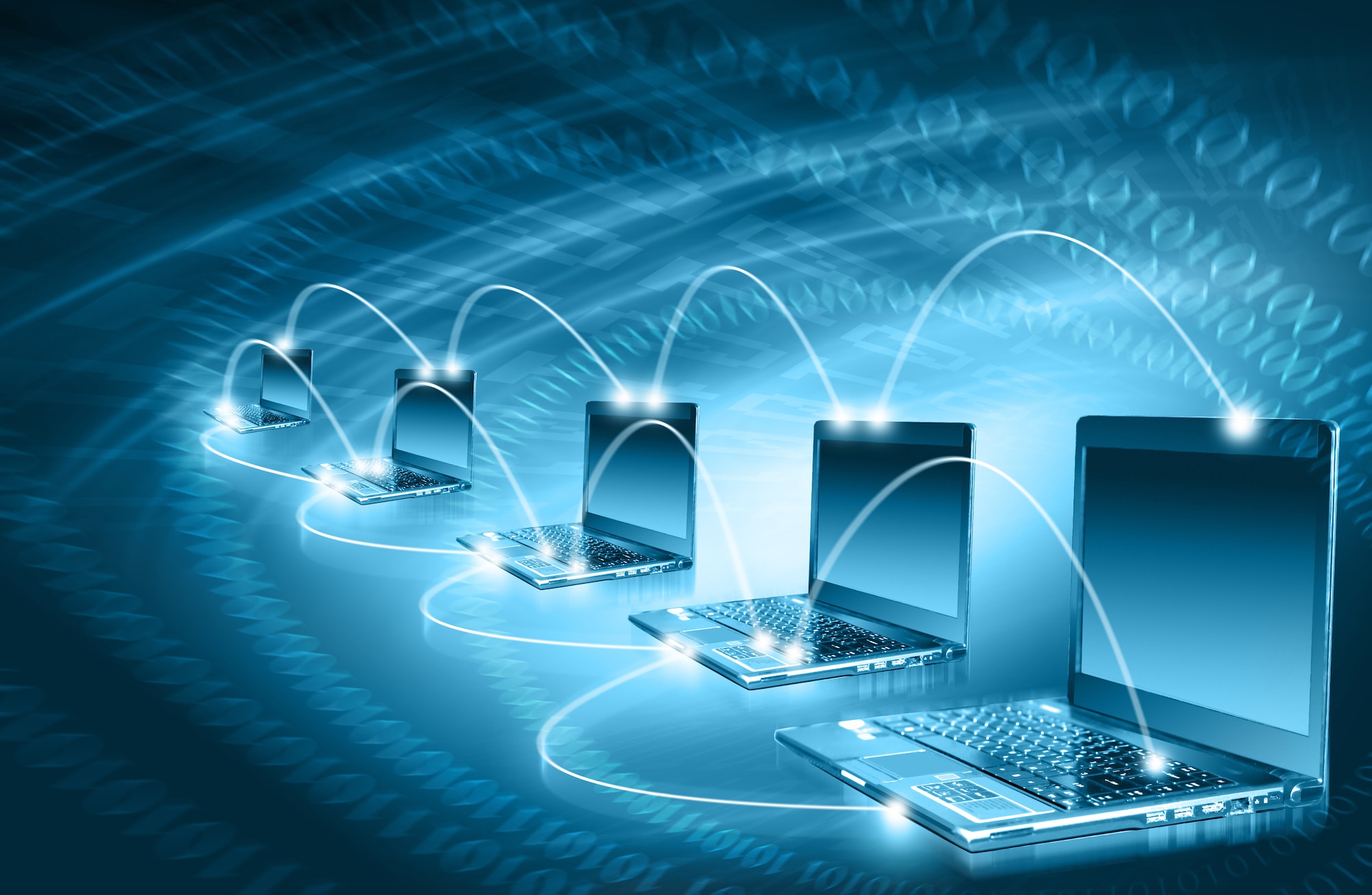 Graphic shows laptops digitally connected to each other.