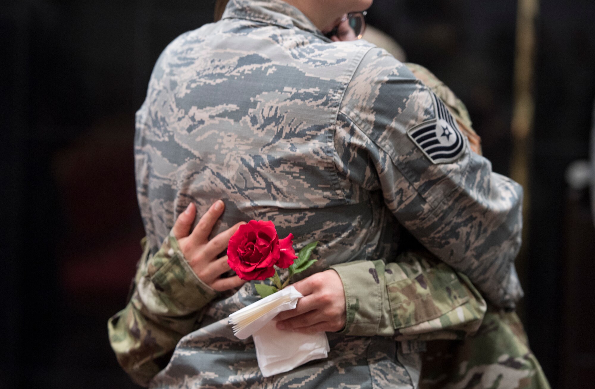 Airmen comfort each other during a memorial service for a colleague who committed suicide, Incirlik Air Base, Turkey, May 17, 2019. In 2019, 137 Airmen in active duty, the Air National Guard and Air Force Reserve. (U.S. Air Force photo by Staff Sgt. Joshua Magbanua)