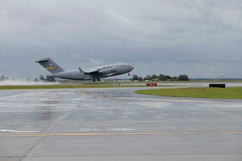 A large transport jet leaves the ground during takeoff.