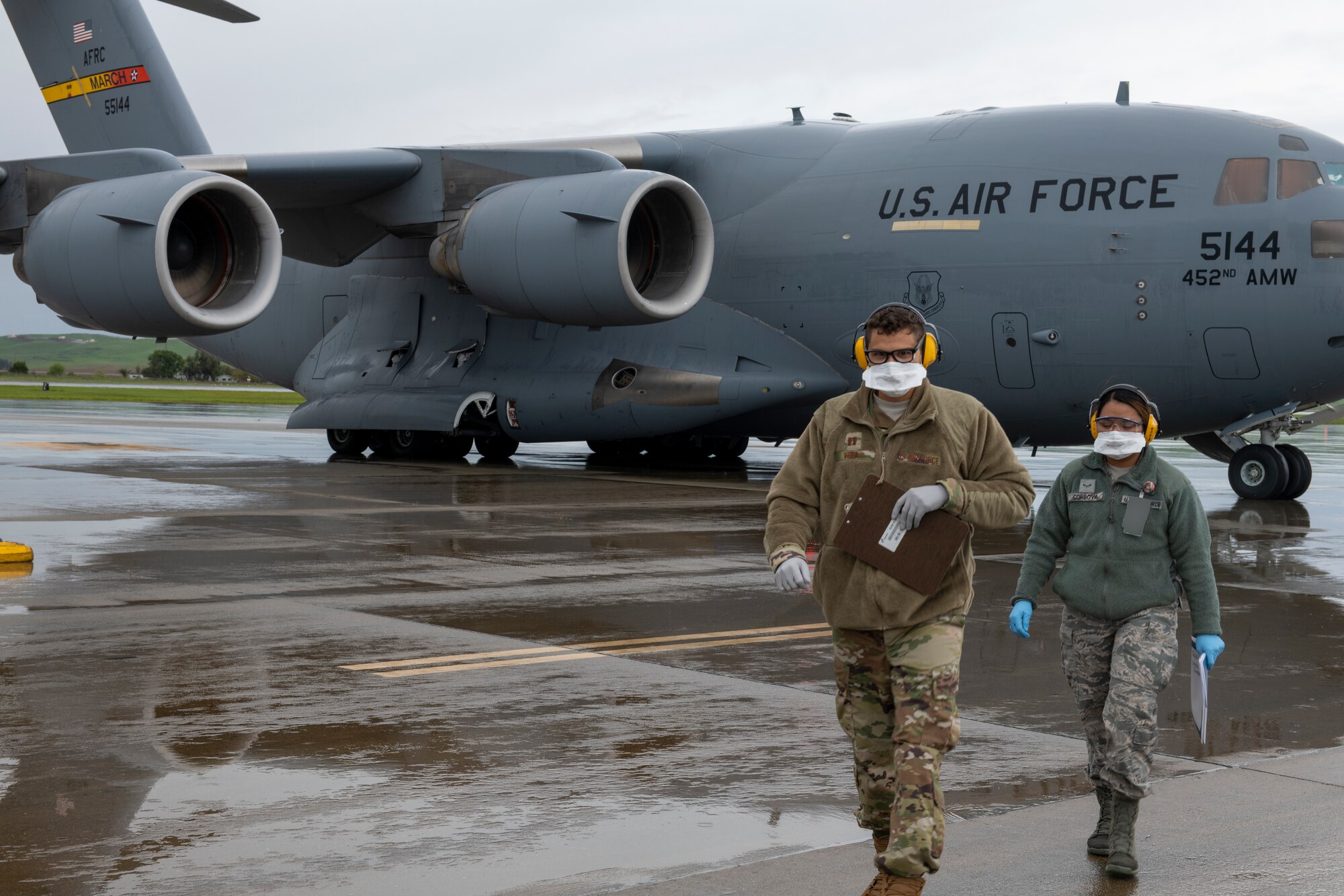 Airmen walk away from a C-17.