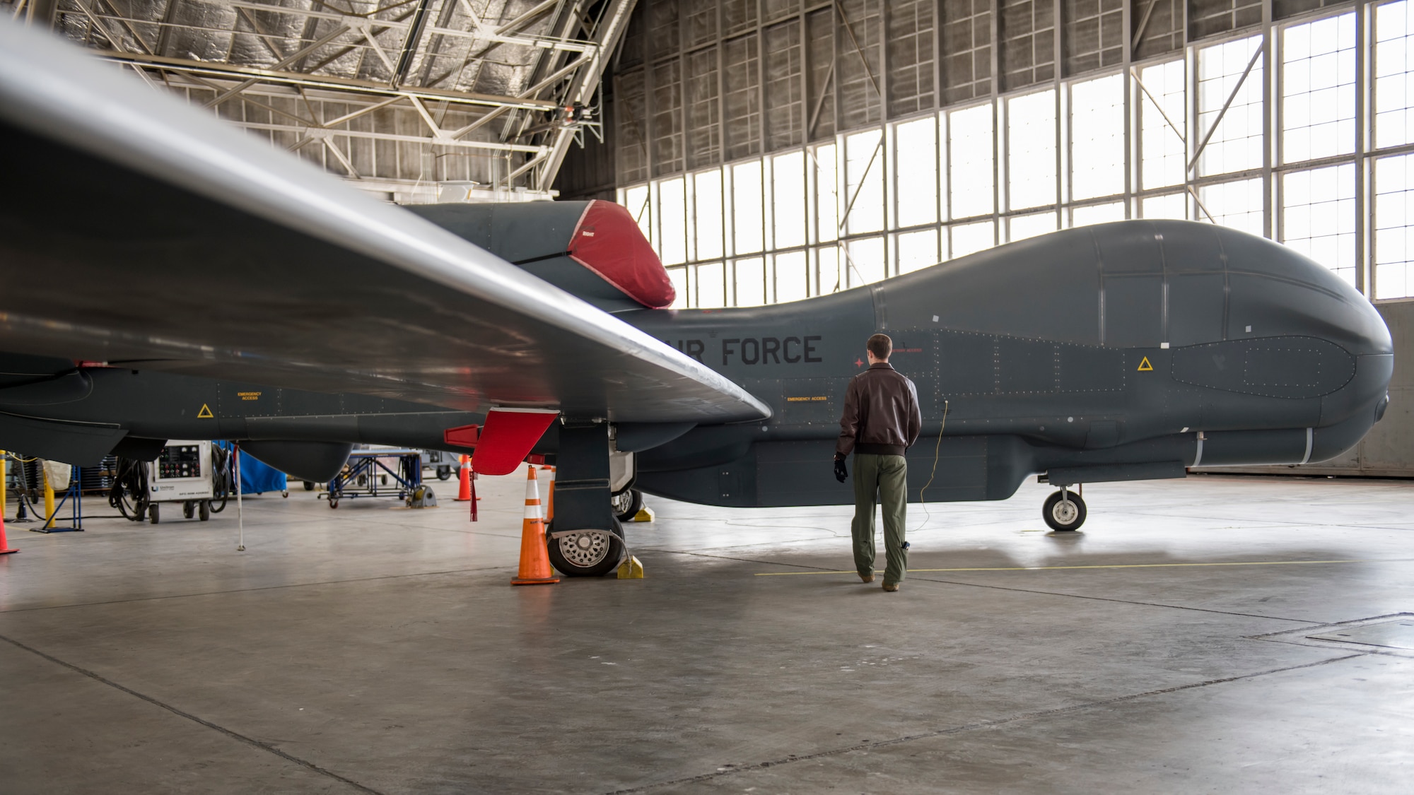 Maj. Marc Nichols, 452nd Flight Test Squadron Assistant Director of Operations, conducts a walk-through inspection of an RQ-4 Global Hawk remotely-piloted aircraft at Edwards Air Force Base, California, April 6. (Air Force photo by Giancarlo Casem)