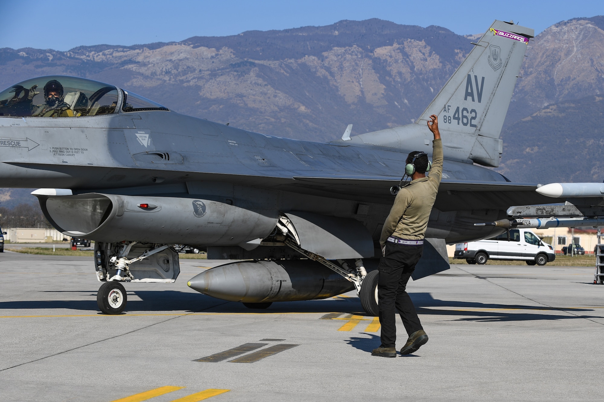 U.S. Air Force Airman Jaquinton Stewart, crew chief for the 510th Fighter Squadron, gives an F-16 pilot the ‘Buzzards’ hand signal at Aviano Air Base, Italy, Apr. 7, 2020. The 510th FS performs air and space control and force application roles of counter-air, strategic attack and counter-land, including interdiction and close-air support, with F-16CMs employing state of the art munitions in support of joint, NATO, and combined operations. (U.S. Air Force photo by Airman Thomas S. Keisler IV)