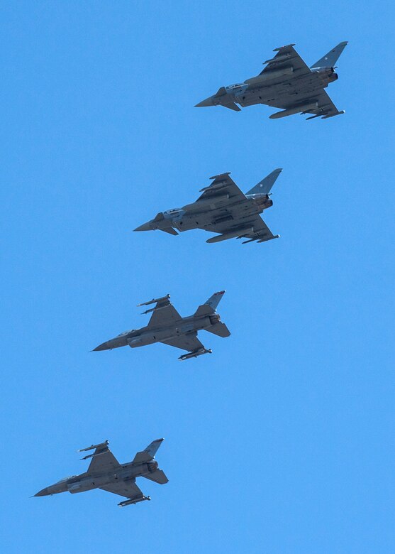 U.S. Fighting Falcons and German Eurofighter Typhoons fly in formation.