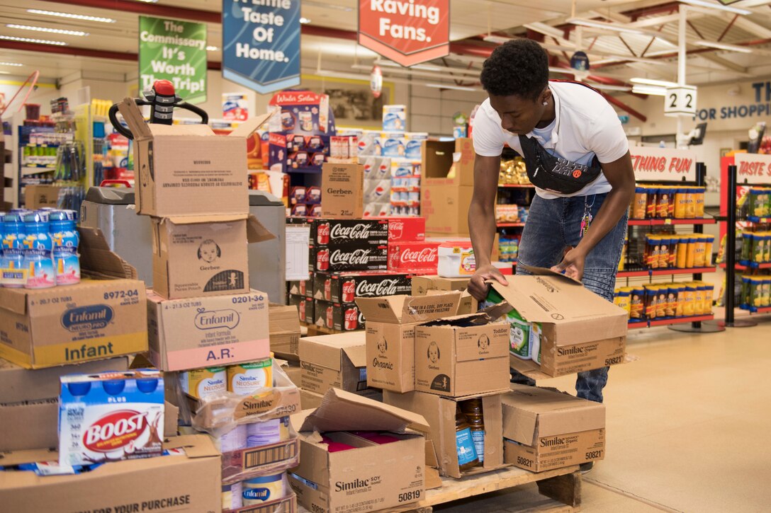 RAF Alconbury and RAF Molesworth employees and volunteers restock shelves at the base commissary at RAF Alconbury England, March 20, 2020. Volunteers answered the call to support the community to ensure service members and their families had access to essential items amid COVID-19. (U.S. Air Force photo by Airman 1st Class Jennifer Zima)