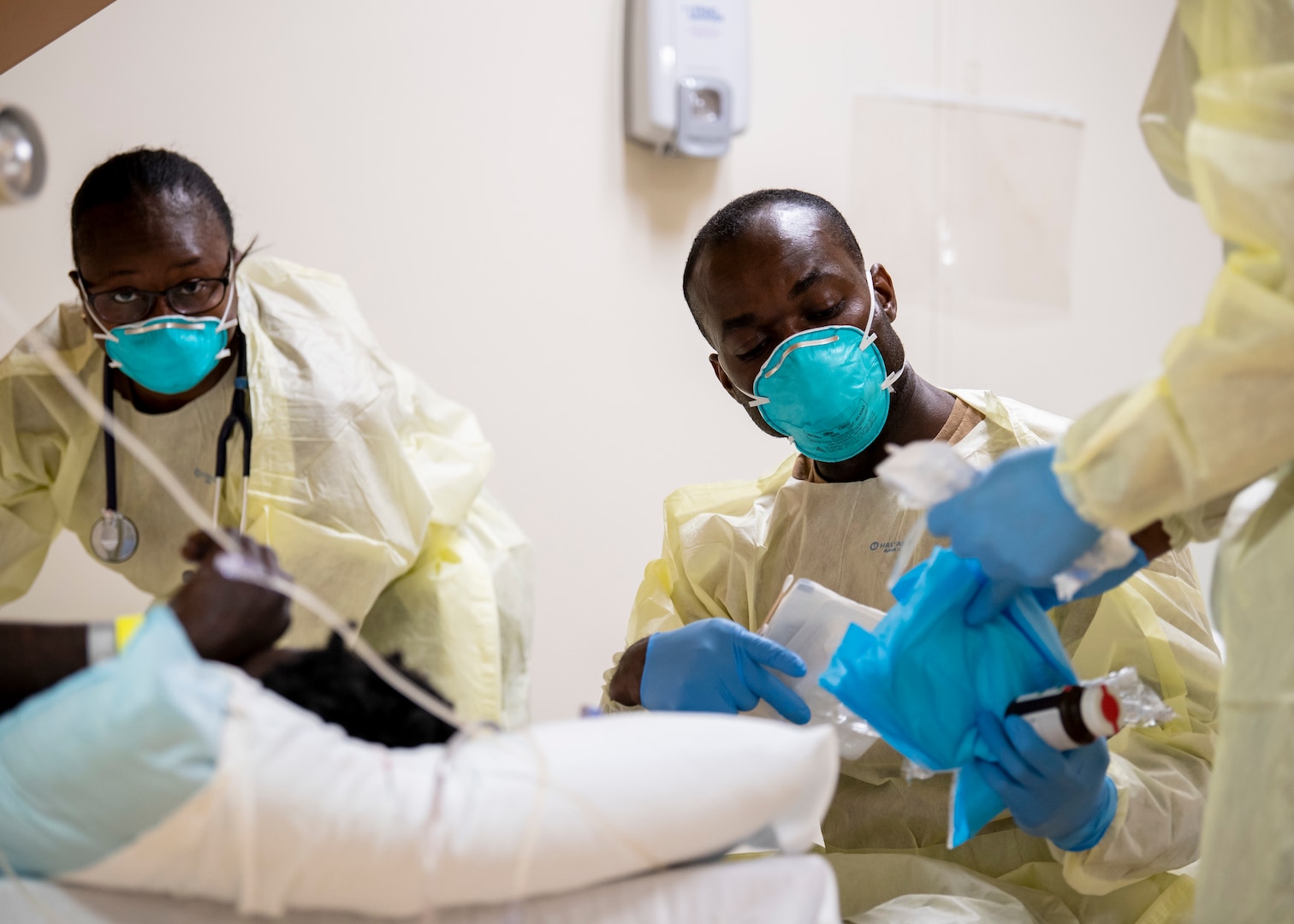 Sailors treat a patient in the ward aboard the hospital ship USNS Mercy (T-AH 19) April 1.