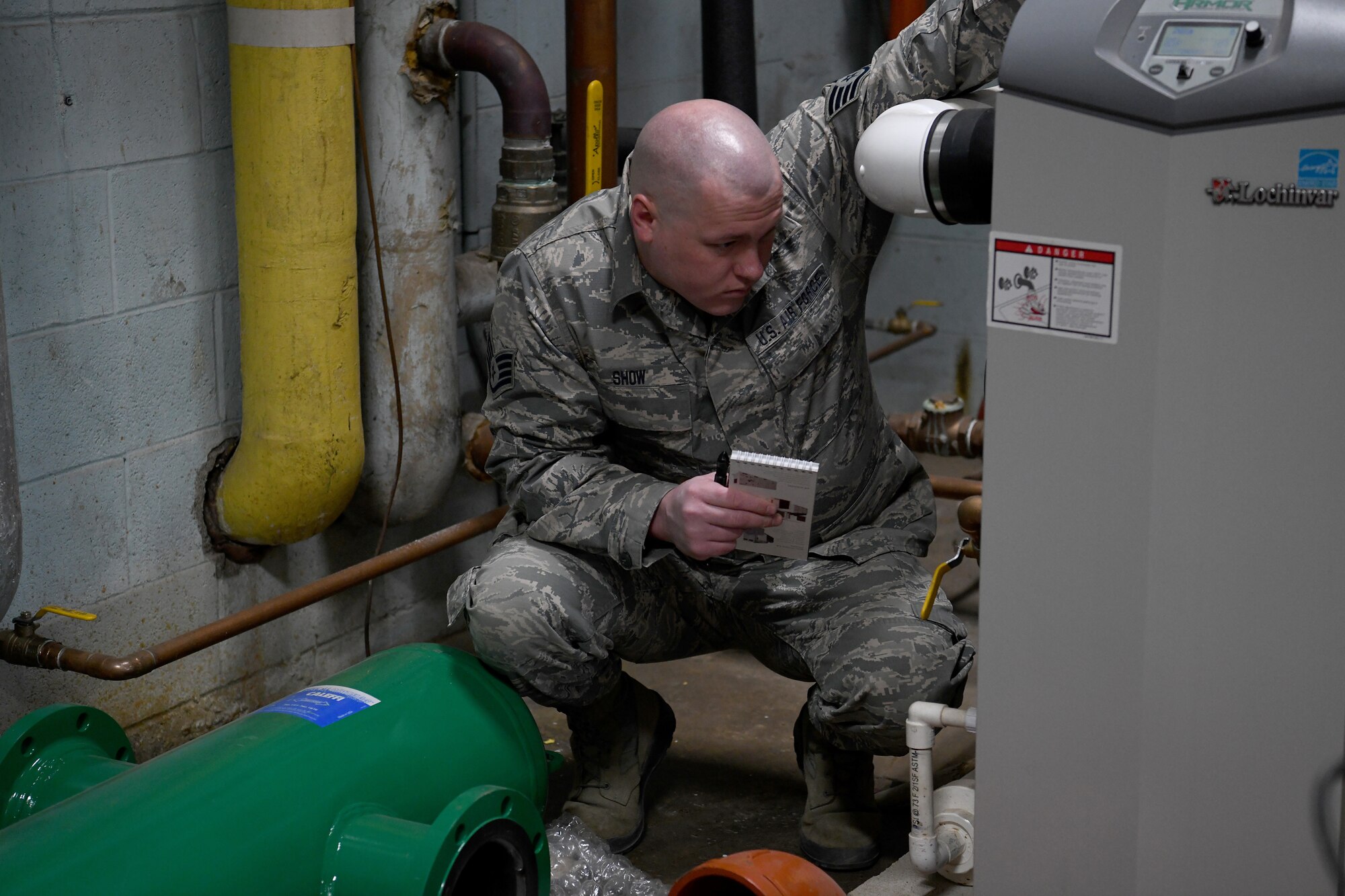 U.S. Air Force Staff Sgt. David Show, an HVAC craftsman with the Ohio National Guard's 200th RED HORSE (Rapid Engineer Deployable Heavy Operational Repair Squadron Engineers) Squadron and currently assigned to the Northwest Joint Engineer Assessment Team, surveys the boiler room at Upper Sandusky High School April 4, 2020, in Upper Sandusky, Ohio. Guard members conducted a site survey at the high school to determine whether it is suitable for potential use as an alternate medical facility, if COVID-19 cases increase beyond what existing hospitals in the state can manage.