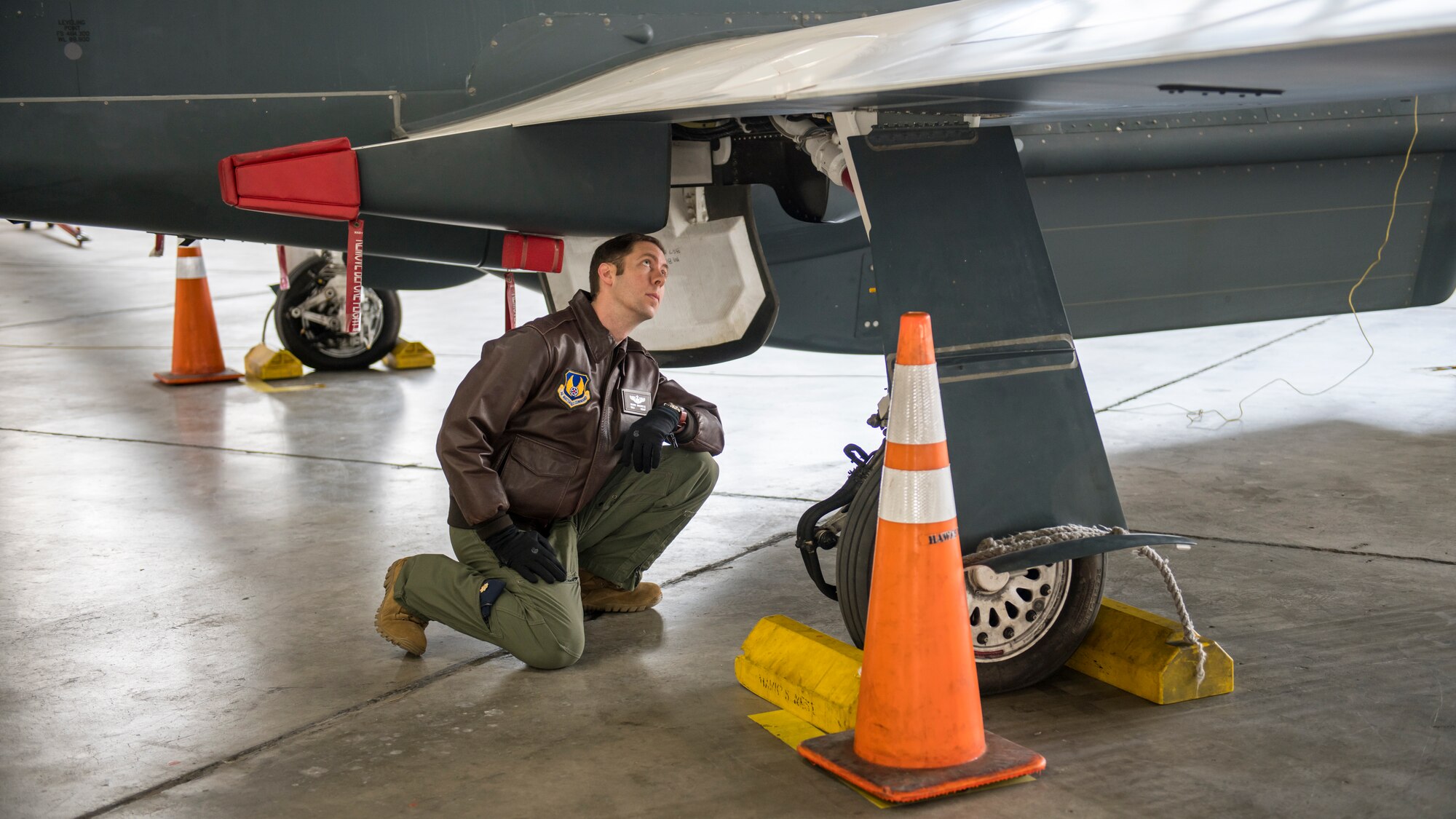 Maj. Marc Nichols, 452nd Flight Test Squadron Assistant Director of Operations, conducts a walk-through inspection of an RQ-4 Global Hawk remotely-piloted aircraft at Edwards Air Force Base, California, April 6. (Air Force photo by Giancarlo Casem)