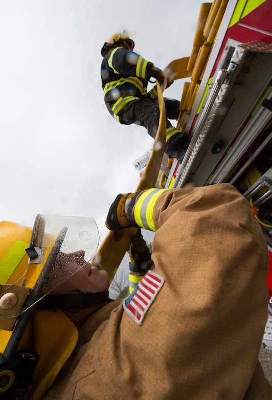 Firefighters with the 423rd Civil Engineer Squadron roll up a firehose during confined spaces training at RAF Alconbury, England on March 30, 2020. This type of training helps the firefighters maintain readiness and stay proficient in their craft. (U.S. Air Force photo by Master Sgt. Brian Kimball)