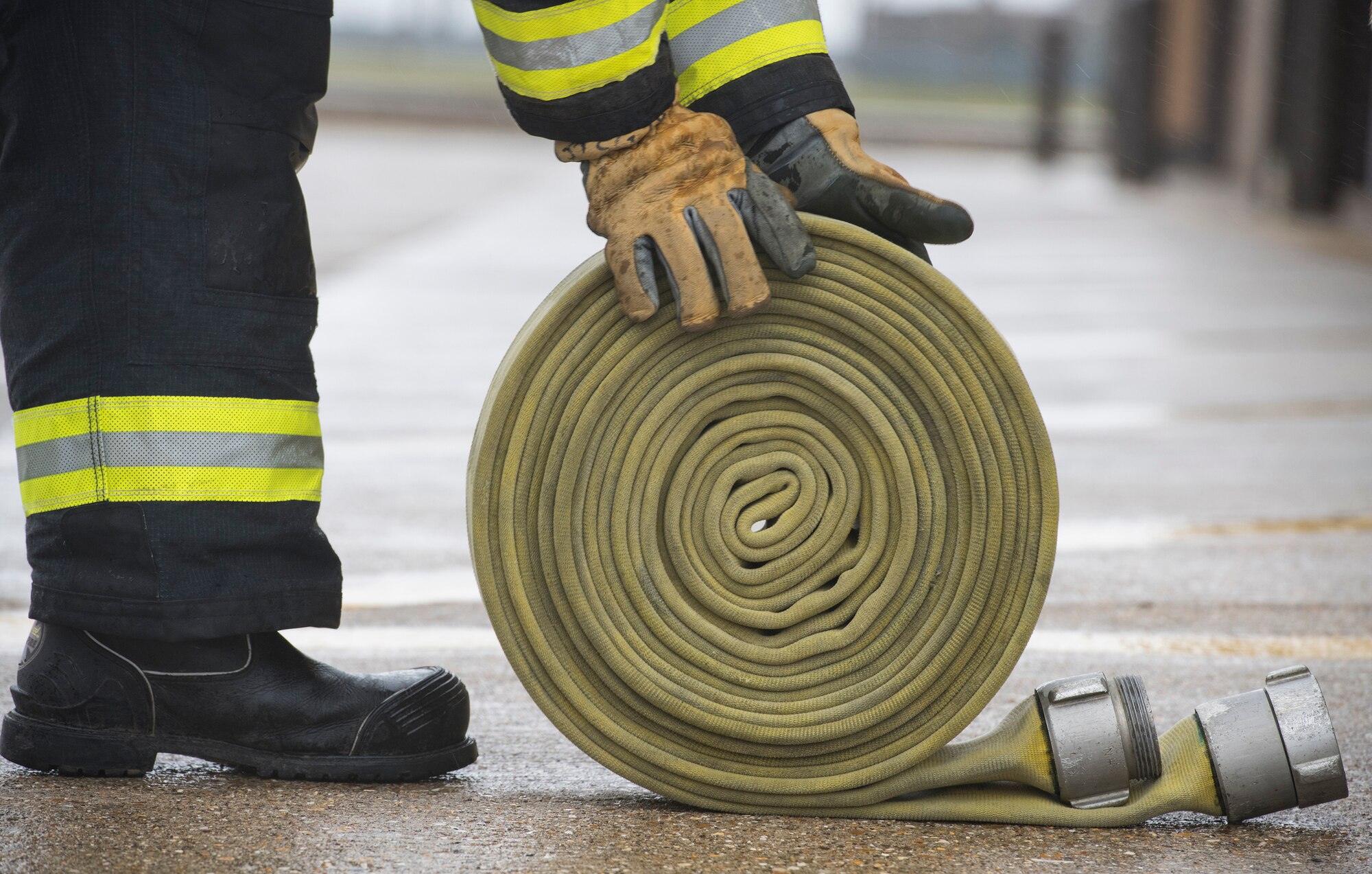 Firefighters with the 423rd Civil Engineer Squadron roll up a firehose during confined spaces training at RAF Alconbury, England on March 30, 2020. This type of training helps the firefighters maintain readiness and stay proficient in their craft. (U.S. Air Force photo by Master Sgt. Brian Kimball)