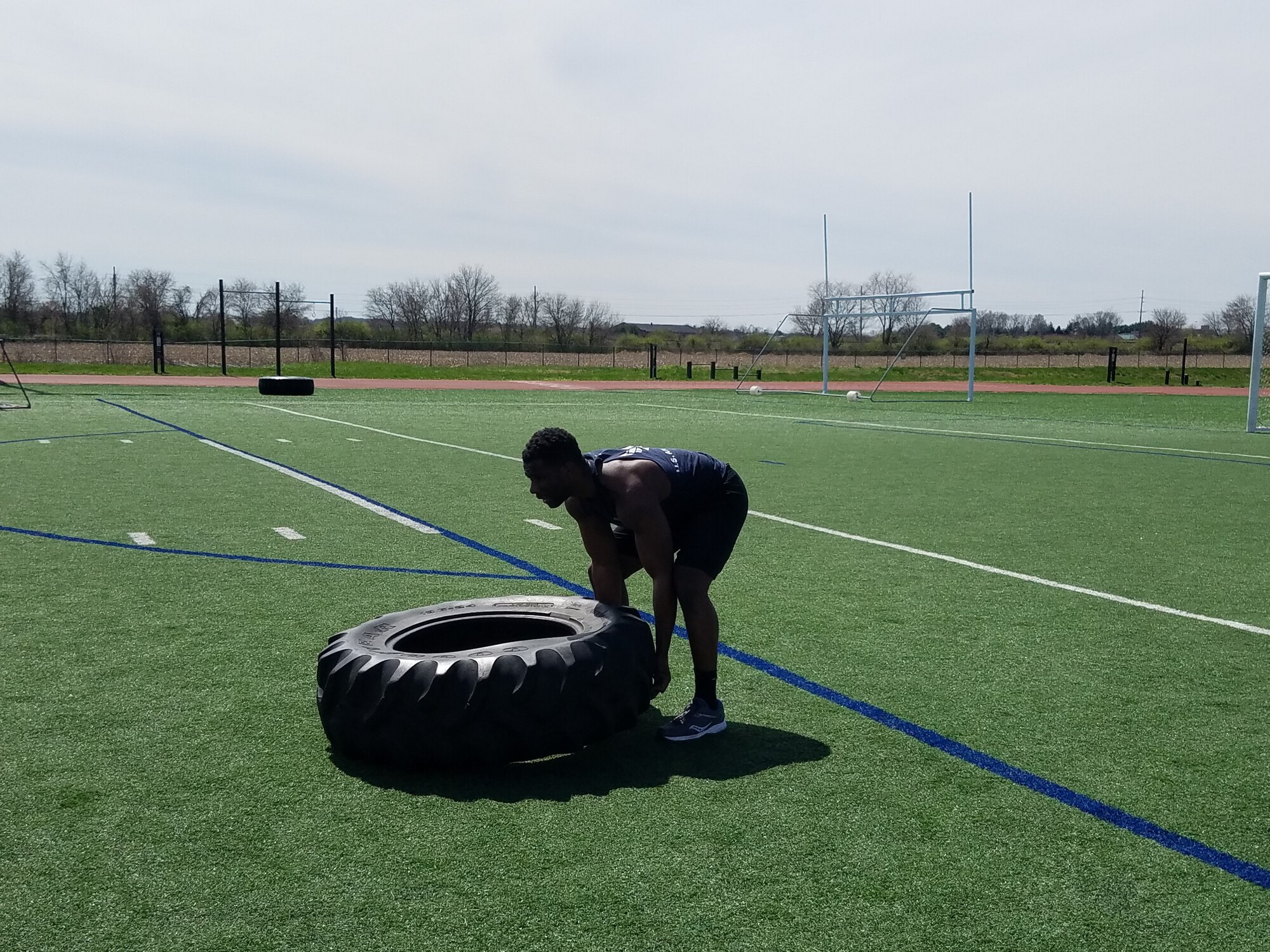 Man lifts tire