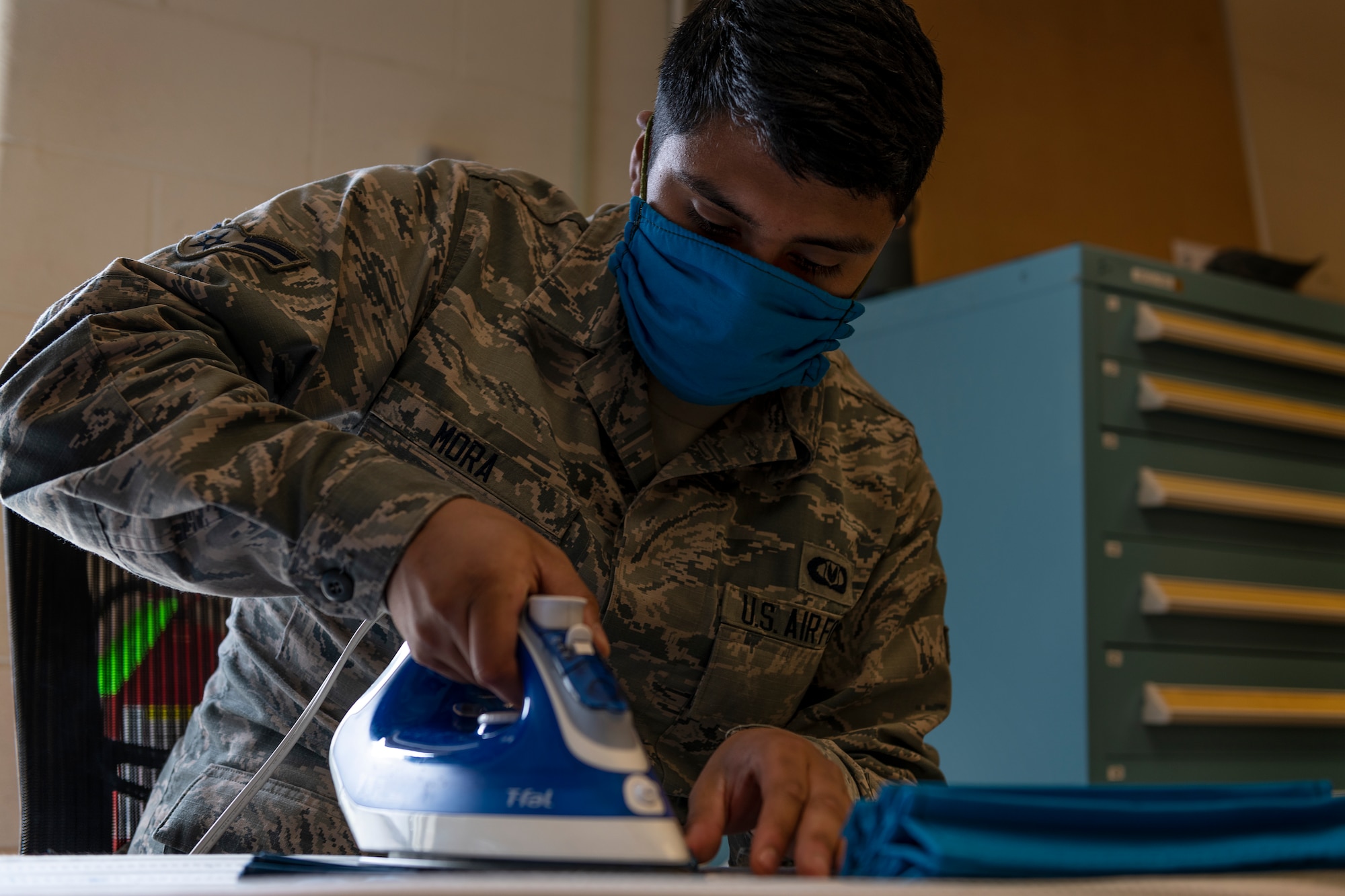 ALTUS AIR FORCE BASE, Okla. - U.S. Air Force Airman First Class Luis Mora, an Air Crew Flight Equipment (AFE) apprentice assigned to the 97th Operations Support Squadron, irons face masks for base members, April 6, 2020 at Altus Air Force Base Oklahoma.