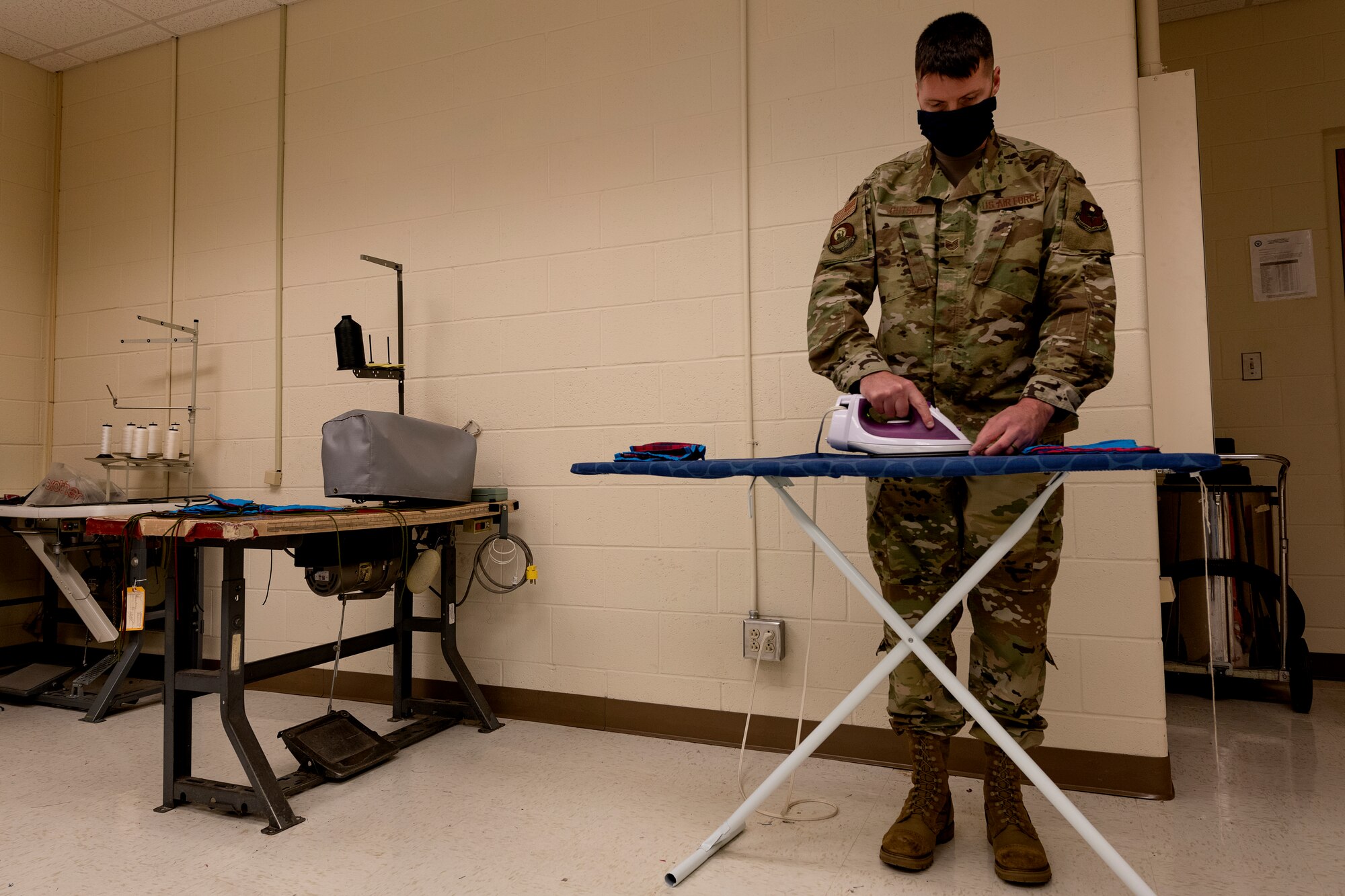 ALTUS AIR FORCE BASE, Okla. - U.S. Air Force Tech. Sgt. Jeremy Gutsch, the assistant flight chief of Air Crew Flight Equipment (AFE) assigned to the 97th Operations Support Squadron, irons face masks for base members, April 6, 2020 at Altus Air Force Base Oklahoma.