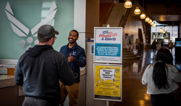 Airman checks ID's at the front desk of the Warrior Fitness Center.
