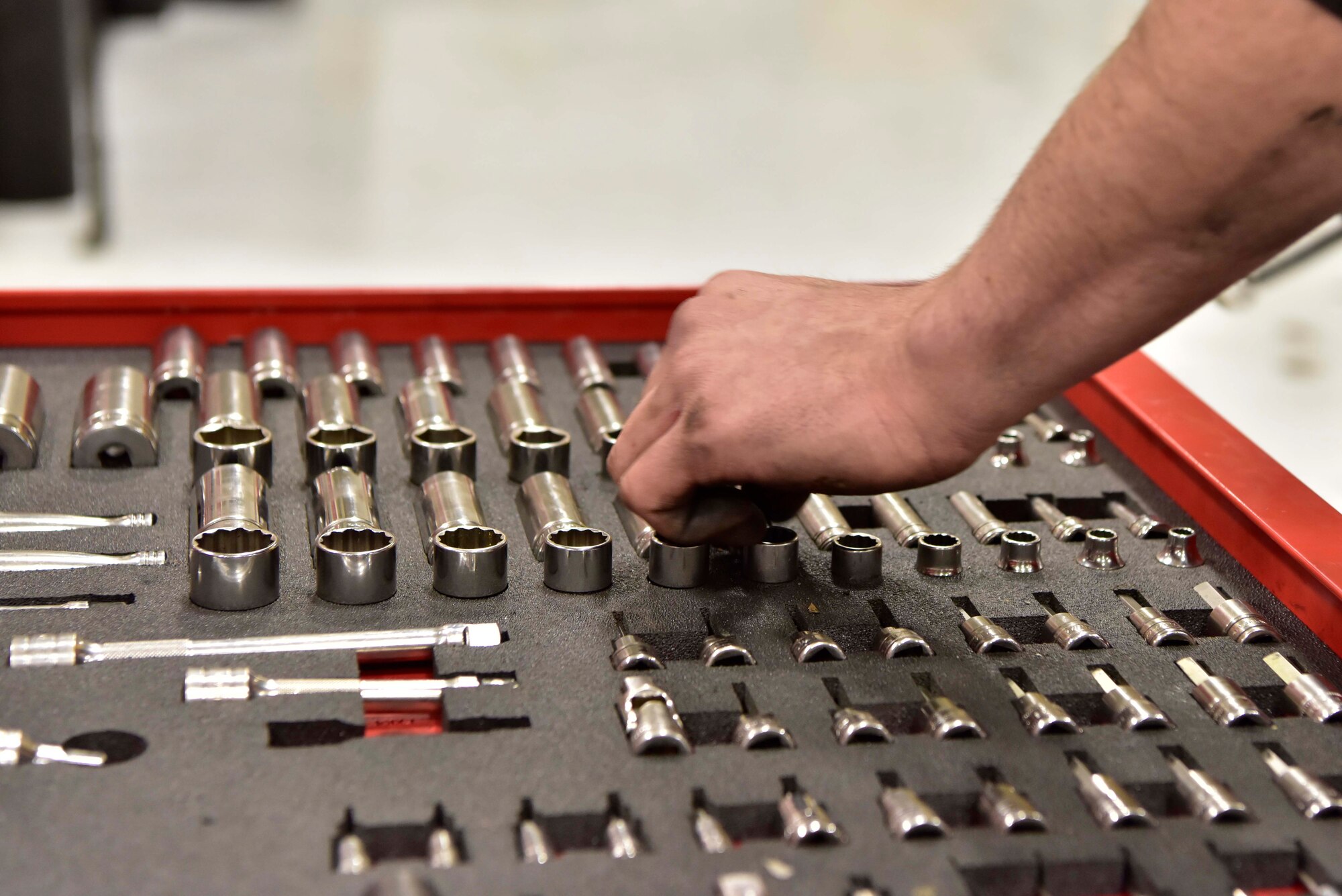 Senior Airman Mathew Bowen, a 354th Logistics Readiness Squadron vehicle maintenance journeyman, selects a socket for repair work at Eielson Air Force Base, Alaska, April 8, 2020. Vehicle mechanics are meticulous in organizing their tools to ensure accountability of all assets. (U.S. Air Force photo by Senior Airman Beaux Hebert)