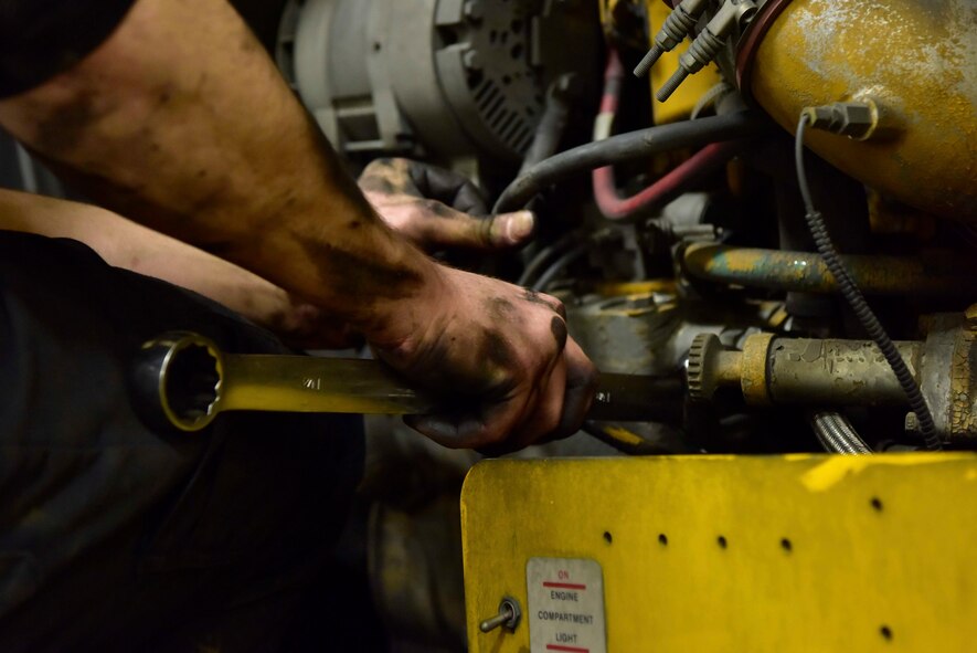 Senior Airman Mathew Bowen, a 354th Logistics Readiness Squadron vehicle maintenance journeyman, uses a wrench to work on an Oshkosh H-series Broom on Eielson Air Force Base, Alaska, April 8, 2020. Vehicle mechanics repair the 354th Civil Engineer Squadron’s snow removal equipment to ensure the flight line stays clear for flying operations. (U.S. Air Force photo by Senior Airman Beaux Hebert)