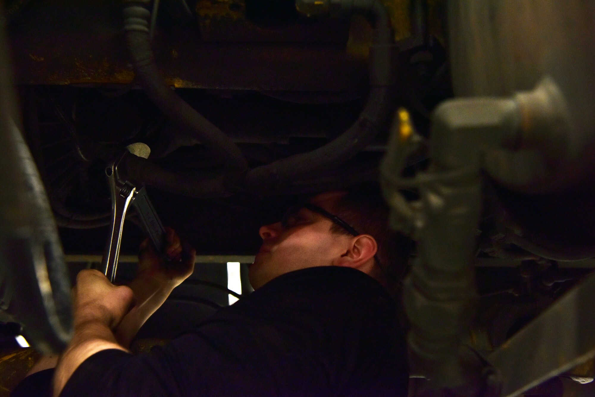 Senior Airman Mathew Bowen, a 354th Logistics Readiness Squadron vehicle maintenance journeyman, loosens an air hose on an Oshkosh H-series Broom on Eielson Air Force Base, Alaska, April 8, 2020. Vehicle mechanics have to work in tight spaces to repair equipment and cannot be afraid to get dirty. (U.S. Air Force photo by Senior Airman Beaux Hebert)