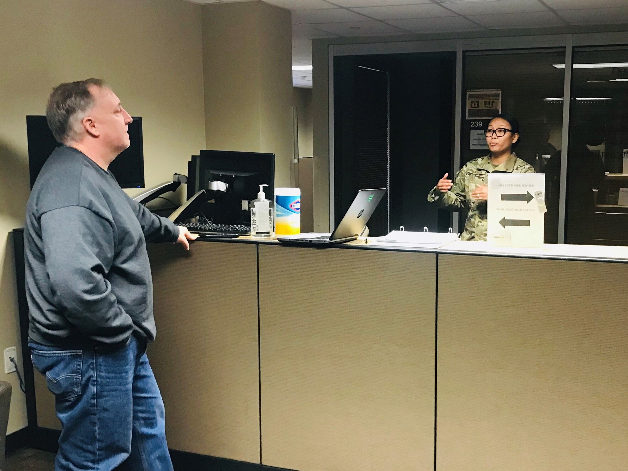 Tech. Sgt. Alexandra Campbell, 926th Force Support Squadron, communications flight chief, assists Robert Wyatt, 926th Wing lead defense travel administrator, with computer issues at Nellis Air Force Base, Nevada, April, 6, 2020.