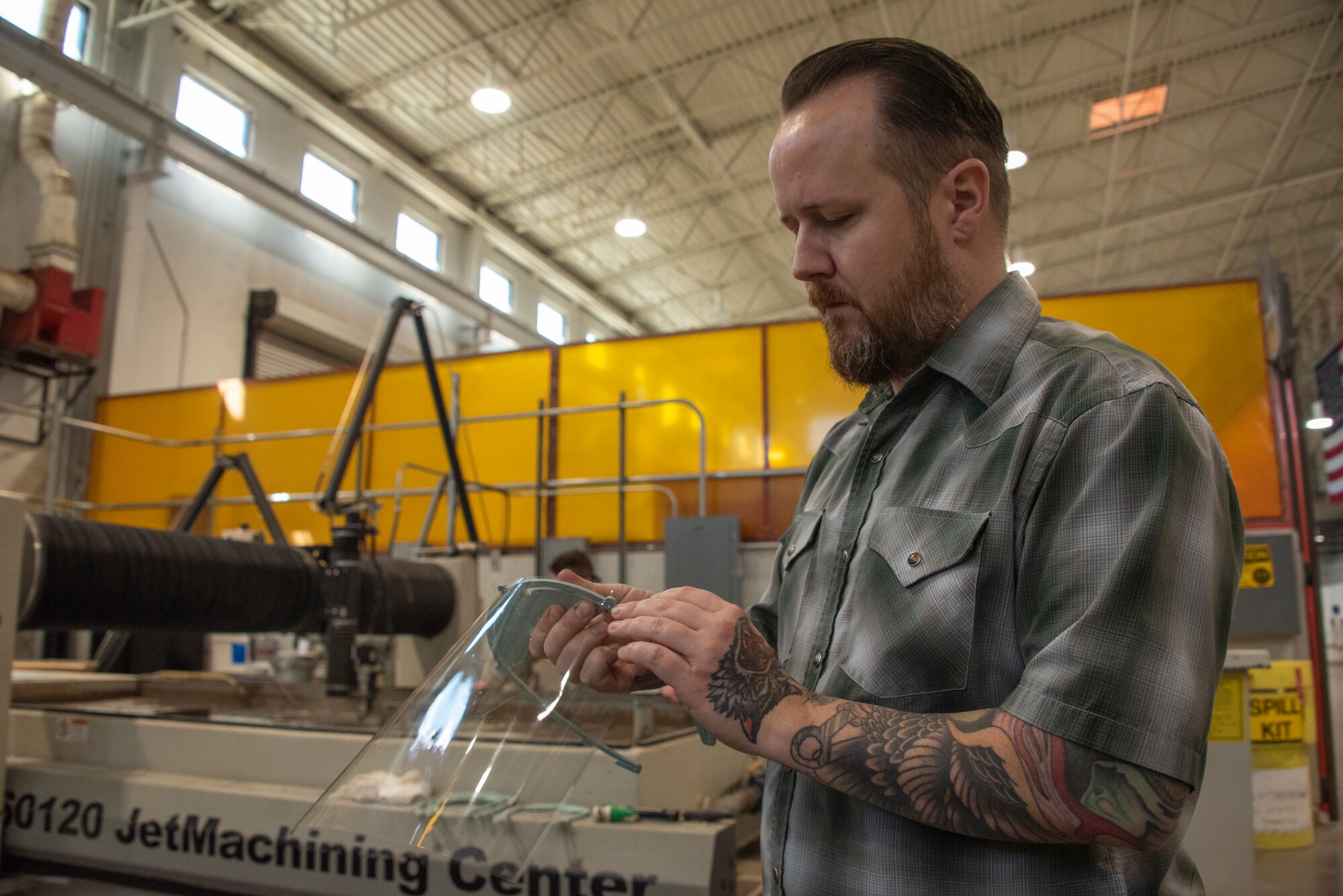 Jeffrey Bruns, 60th Maintenance Squadron sheet metal section chief, assembles a face shield prototype March 31, 2020, at Travis Air Force Base, California. The 60th Air Mobility Wing Phoenix Spark innovation cell, 60th MXS and 60th Bioenvironmental Engineer Squadron collaborated to come up with easy-to-manufacture PPE for David Grant USAF Medical Center personnel. (U.S. Air Force photo by Tech. Sgt. Traci Keller)