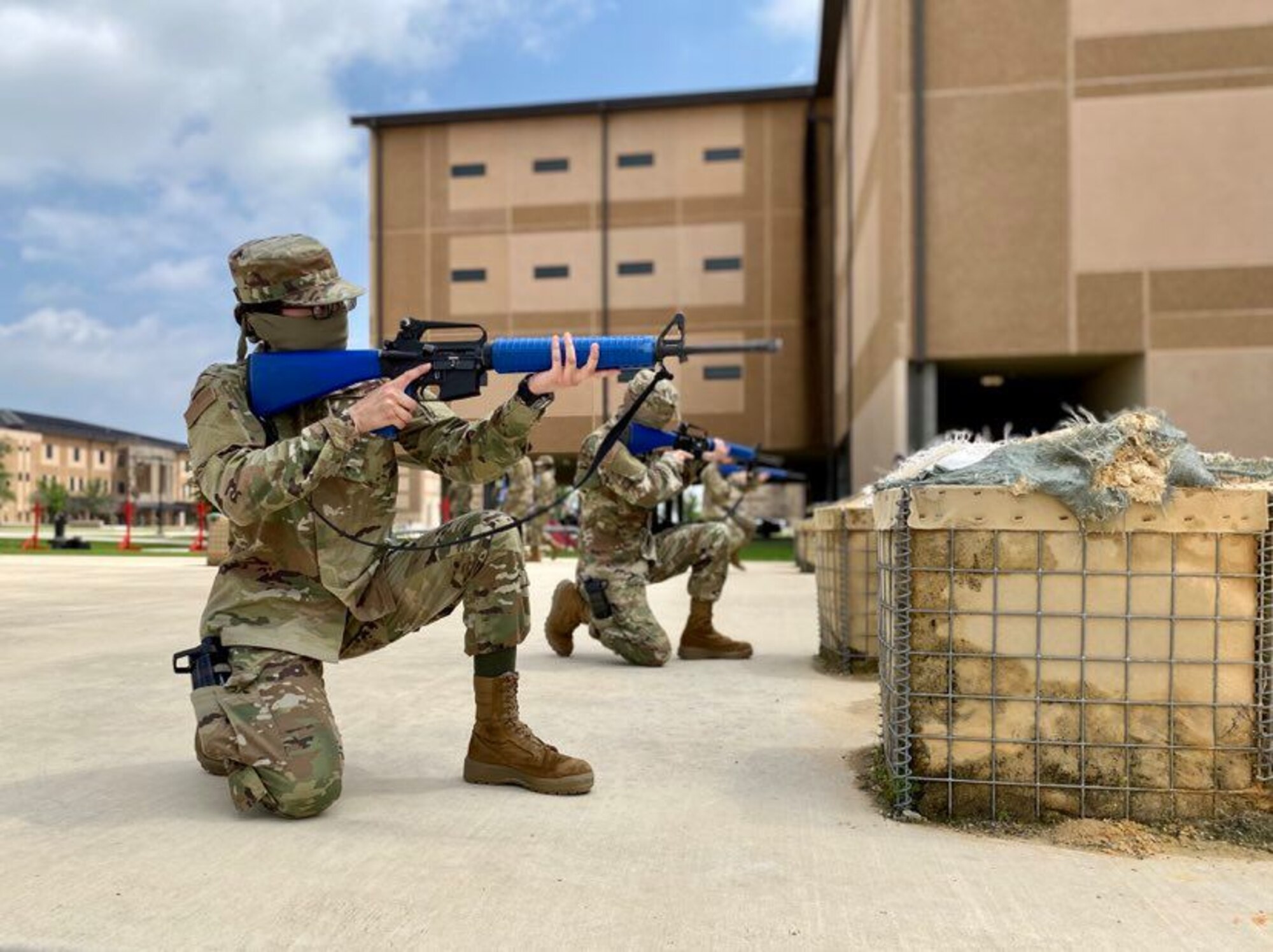 Trainees in basic military training (BMT) learn defensive fighting positions in preparation for BEAST (Basic Expeditionary Airman Skills Training) on Joint Base San Antonio-Lackland, Texas, April 8. This was the first day mask wear was implemented at BMT as a required safety measure during the COVID-19 pandemic.