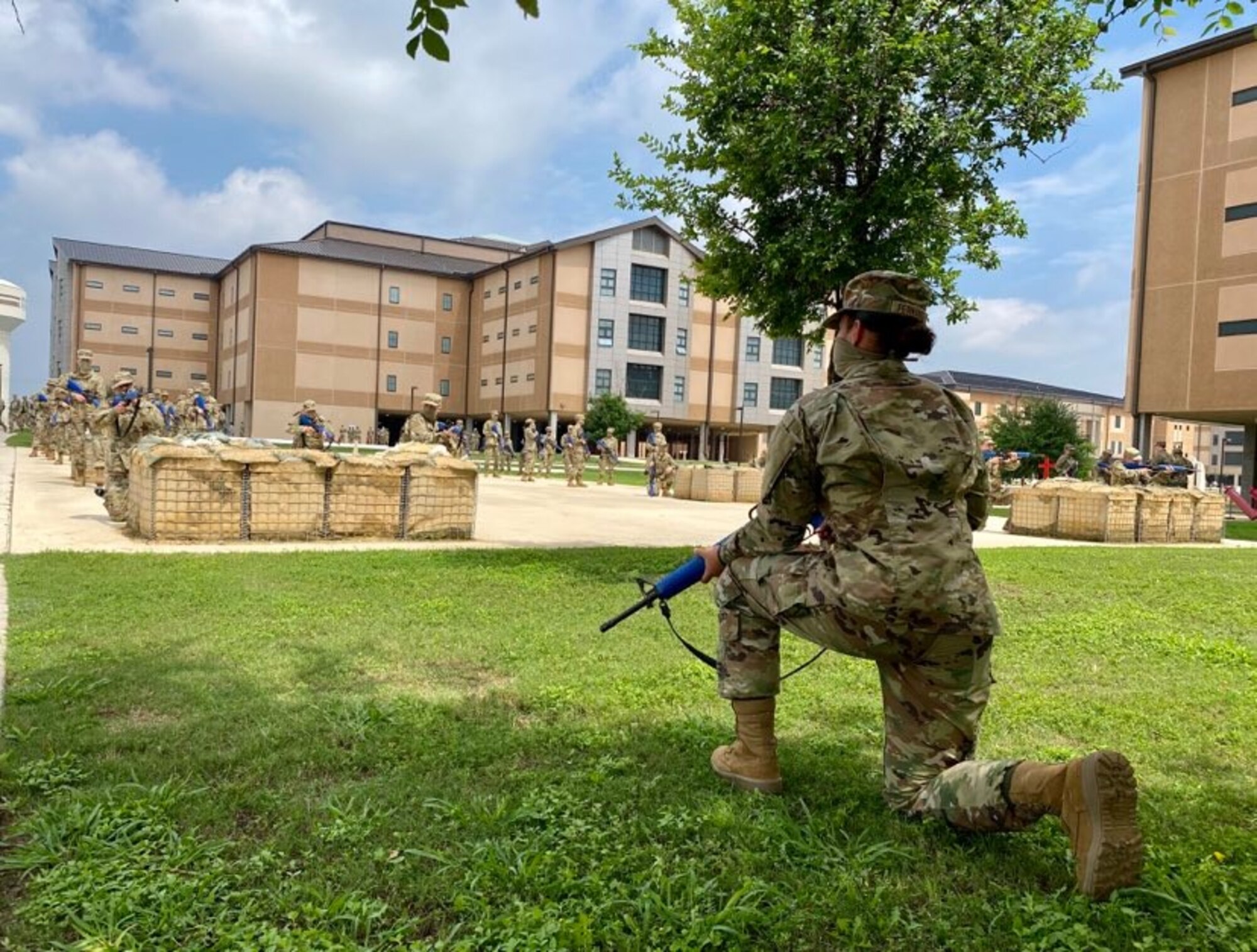 Trainees in basic military training (BMT) learn defensive fighting positions in preparation for BEAST (Basic Expeditionary Airman Skills Training) on Joint Base San Antonio-Lackland, Texas, April 8. This was the first day mask wear was implemented at BMT as a required safety measure during the COVID-19 pandemic.