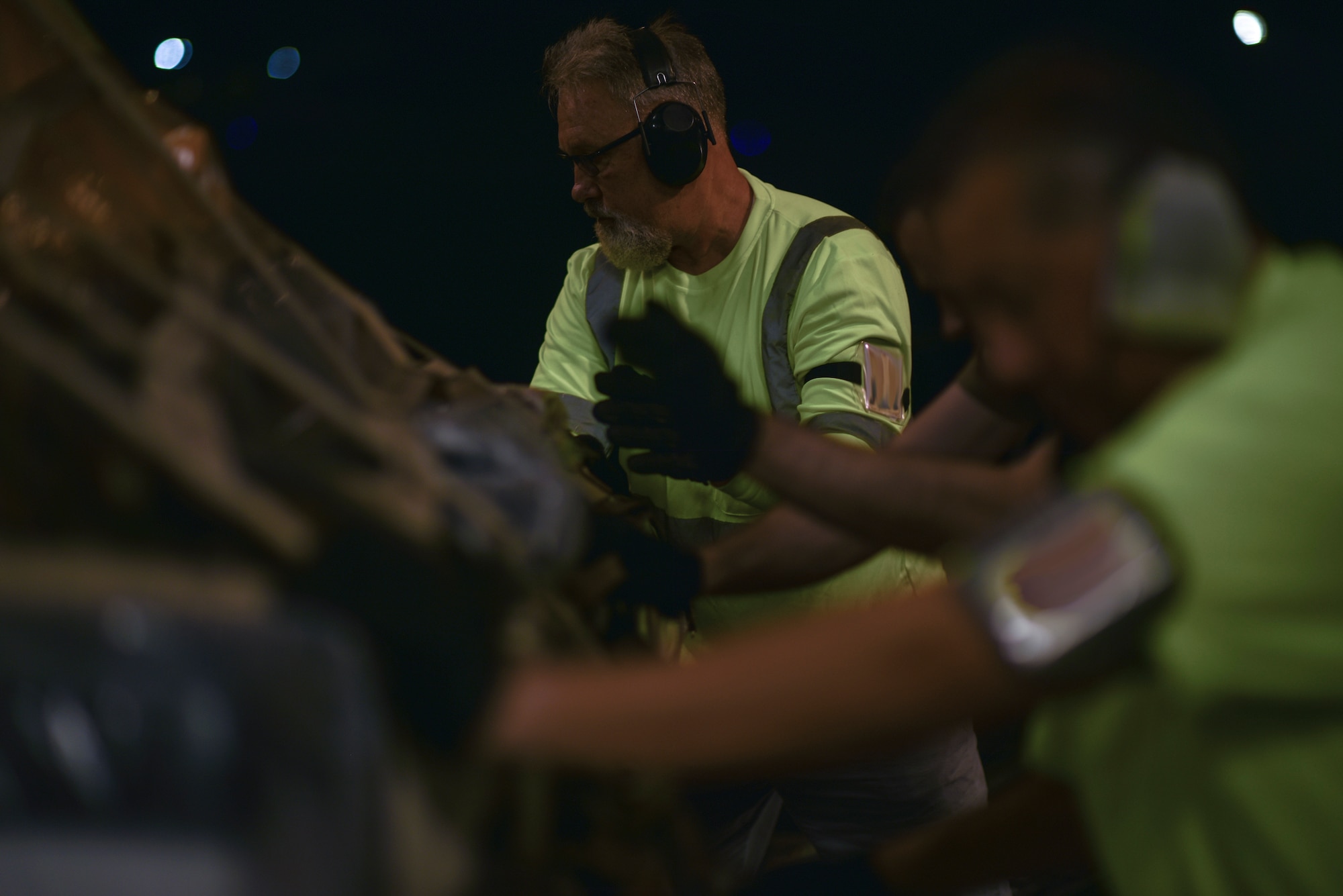 Bruce Miller, 735th Air Mobility Squadron Aircraft loader, moves COVID-19 personal protective equipment and medical supplies onto a  C-17 Globemaster III from the 535th Airlift Squadron at Joint Base Pearl Harbor-Hickam, Hawaii, April  3, 2020. The 735th AMS provided support to the Mariana Islands in response to the COVID-19 pandemic.  

 (U.S. Air Force photo by Tech. Sgt. Anthony Nelson Jr.)