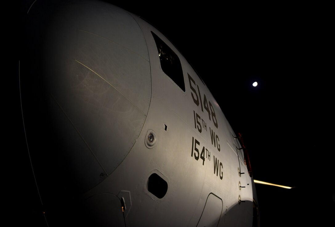 A 535th Airlift Squadron  A C-17 Globemaster III from the 535th Airlift Squadron sits on the flightline at Joint Base Pearl Harbor-Hickam, Hawaii, April  3, 2020. The 735th Air Mobility Squadron Three Tunner 60K loaders assigned to the  The 735th Air Mobility Squadron loaded 31,063 pounds of cargo containing COVID-19 personal protective equipment and medical supplies from the CDC and FEMA that were to be delivered to the Mariana Islands.  (U.S. Air Force photo by Tech. Sgt. Anthony Nelson Jr.)