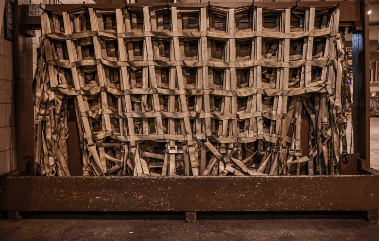 The 735th Air Mobility Squadron uses top net to provide additional restraint to cargo while in flight at Joint Base Pearl Harbor-Hickam, Hawaii, April  3, 2020. The 735th AMS provided support to the Mariana Islands in response to the COVID-19 pandemic.  

 (U.S. Air Force photo by Tech. Sgt. Anthony Nelson Jr.)