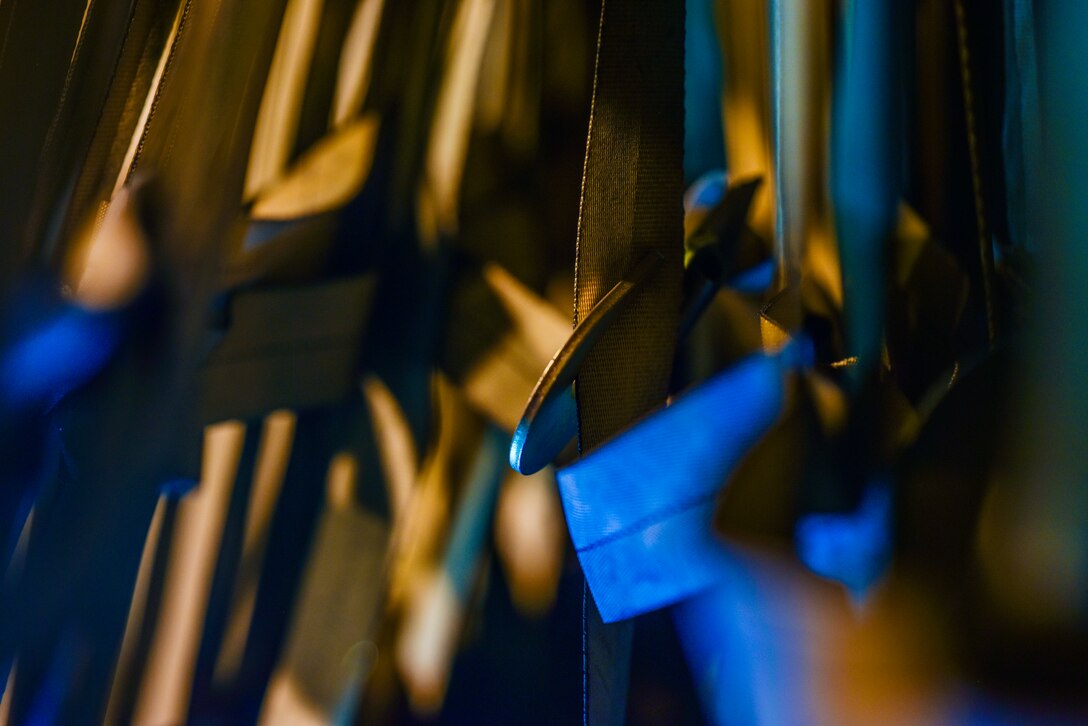 U.S. Air Force Airmen assigned to the 735th Air Mobility Squadron, use top and side nets to secure pallets at Joint Base Pearl Harbor-Hickam, Hawaii, April  3, 2020. The hook is used for securing the top. With a 72-hour notification the 735th AMS loaded 31,063 pounds of cargo in support of the COVID-19 response. (U.S. Air Force photo by Tech. Sgt. Anthony Nelson Jr.)