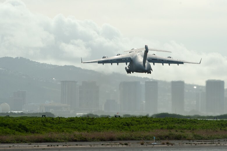 A 535th Airlift Squadron A C-17 Globemaster III takes off from Joint Base Pearl Harbor-Hickam, Hawaii, April  3, 2020.  The 735th Air Mobility Squadron loaded 31,063 pounds of cargo containing COVID-19 personal protective equipment and medical supplies from the CDC and FEMA that were delivered to the Mariana Islands.  (U.S. Air National Guard photo by Senior Airman John Linzmeier)