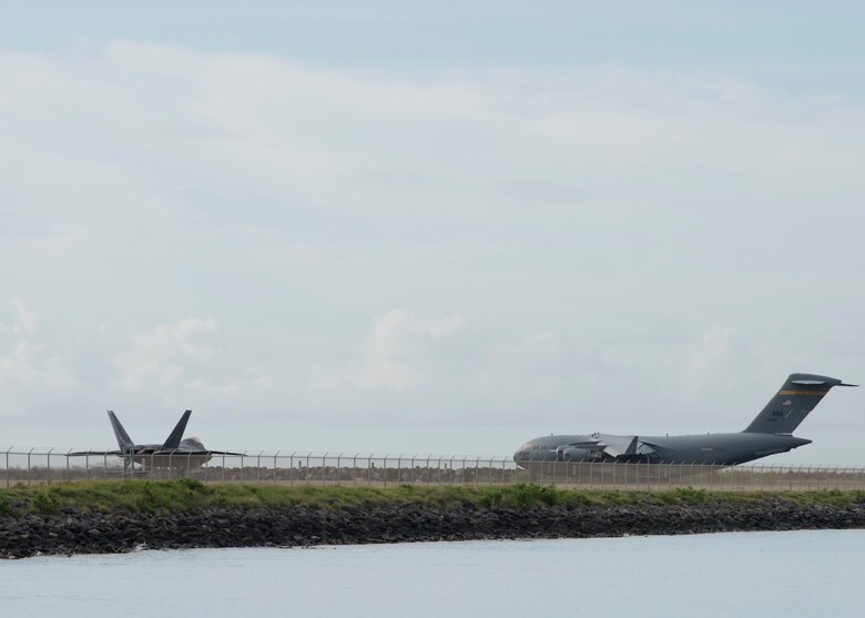 A C-17 Glbomaster III prepares for take off on the flightline at Joint Base Pearl Harbor-Hickam, Hawaii, April  3, 2020. With a 72-hour notification the 735th AMS loaded 31,063 pounds of cargo in support of the COVID-19 response.  (U.S. Air Force photo by Staff. Sgt. Mikaley Kline )
