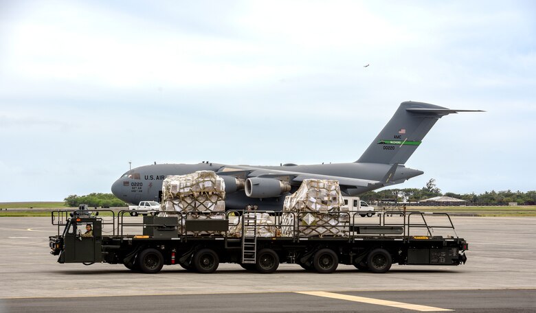 U.S. Air Force Senior Airman Mario Garcia, 735th Air Mobility Squadron air freight journeyman, drives a Tunner 60K loader with cargo to the 735th AMS dock at Joint Base Pearl Harbor-Hickam, Hawaii, March 31, 2020. The 735th AMS supports global airlift in the Indo-Pacific region. (U.S. Air Force photo by Tech. Sgt. Anthony Nelson Jr.)