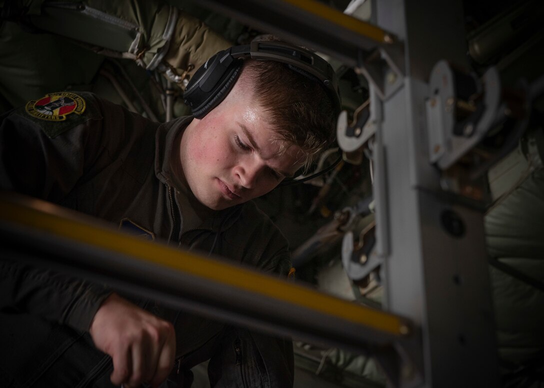 Senior Airman Anthony Griffin, 36th Airlift Squadron loadmaster, installs a strap to hold up litters to execute an aeromedical evacuation scenario during the Yokota C‐130J Tactics Rodeo April 3, 2020, at Yokota Air Base, Japan.