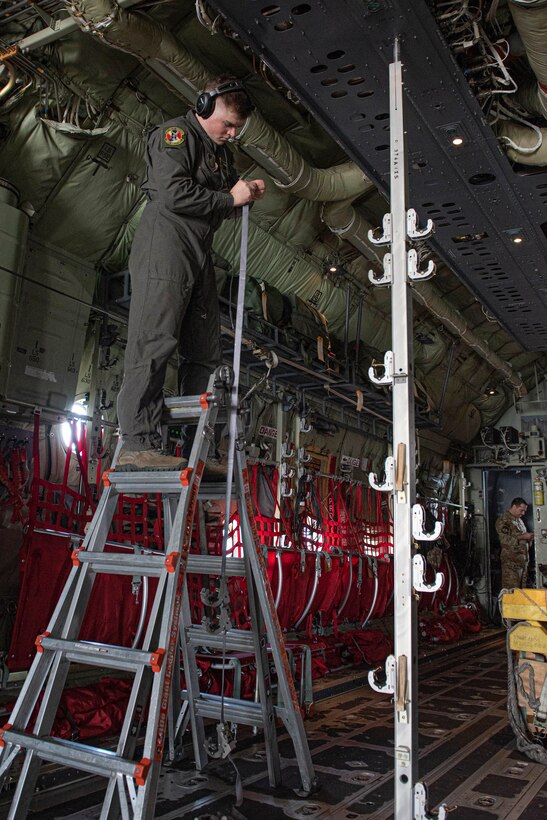 Senior Airman Anthony Griffin, 36th Airlift Squadron loadmaster, installs a strap to hold up litters to execute an aeromedical evacuation scenario during the Yokota C‐130J Tactics Rodeo April 3, 2020, at Yokota Air Base, Japan.