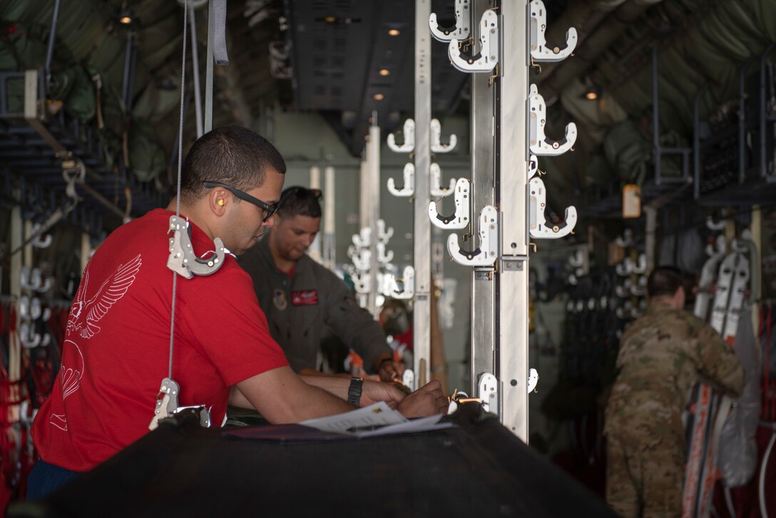 Tech. Sgt. Brian Gates, 36th Airlift Squadron NCO in charge of tactics, secures a litter into a hanging strap on a C‐130J Super Hercules to evaluate an aircrew’s performance during the Yokota C‐130J Tactics Rodeo April 3, 2020, at Yokota Air Base, Japan.