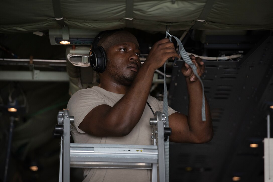 Staff Sgt. Marcus Wright, 36th Airlift Squadron C‐130J Super Hercules loadmaster, hangs a litter strap prior to executing an aeromedical evacuation scenario during the Yokota C‐130J Tactics Rodeo April 3, 2020, at Yokota Air Base, Japan.